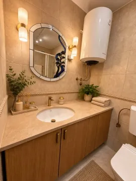 Decorated bathroom with a sink, mirror, and water heater. - image 8
