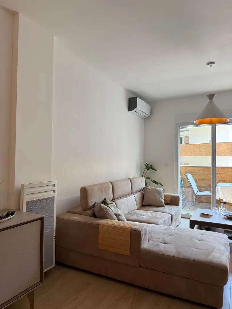 Living room with a sectional sofa and access to the terrace.