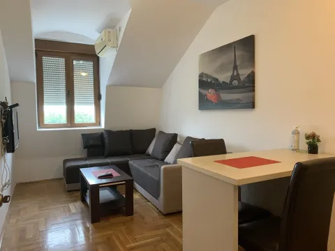 Living room with a corner sofa and a table. - image 5