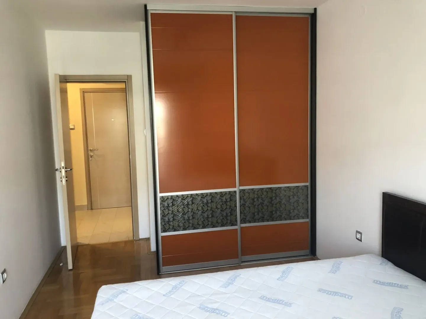 Bedroom with a large built-in wardrobe and a double bed.