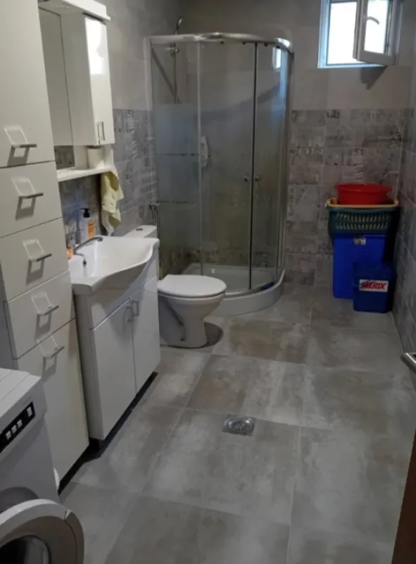 Kupatilo sa tuš kabinom, umivaonikom, WC šoljom i veš mašinom.