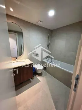 Modern bathroom with a bathtub, washbasin, and toilet. - image 17