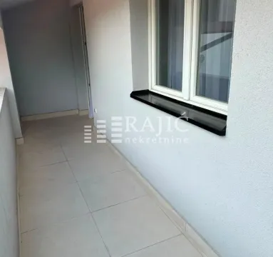 View of a spacious balcony with ceramic tiles and a window. - image 7