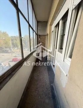 Enclosed balcony with street view. - image 11