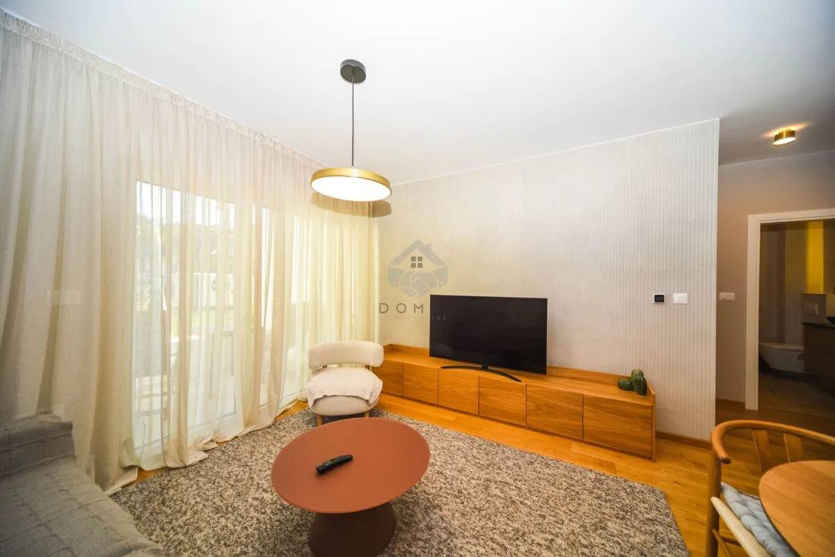 Living room with furniture, TV and access to the terrace.