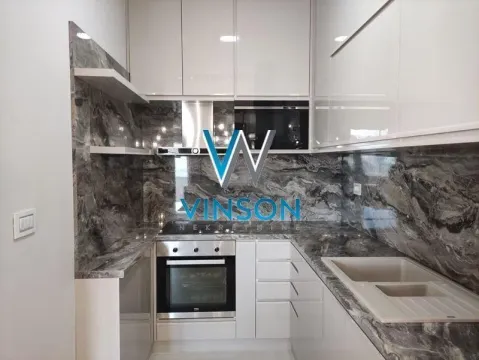 Kitchen with built-in appliances and marble-look countertops. - image 9