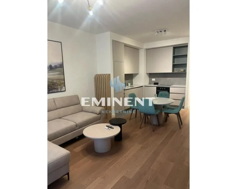 Living room with a sofa and dining area integrated with the kitchen.