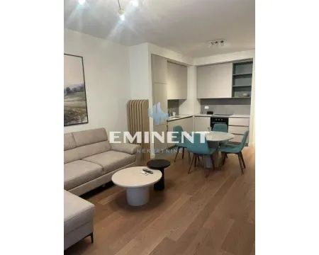Living room with a sofa and dining area integrated with the kitchen. - image 4