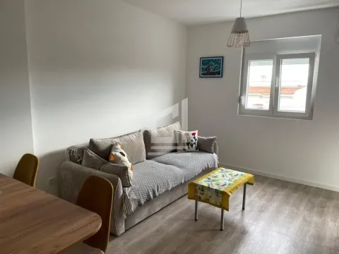 Living room with a sofa, coffee table, and dining table. - image 4
