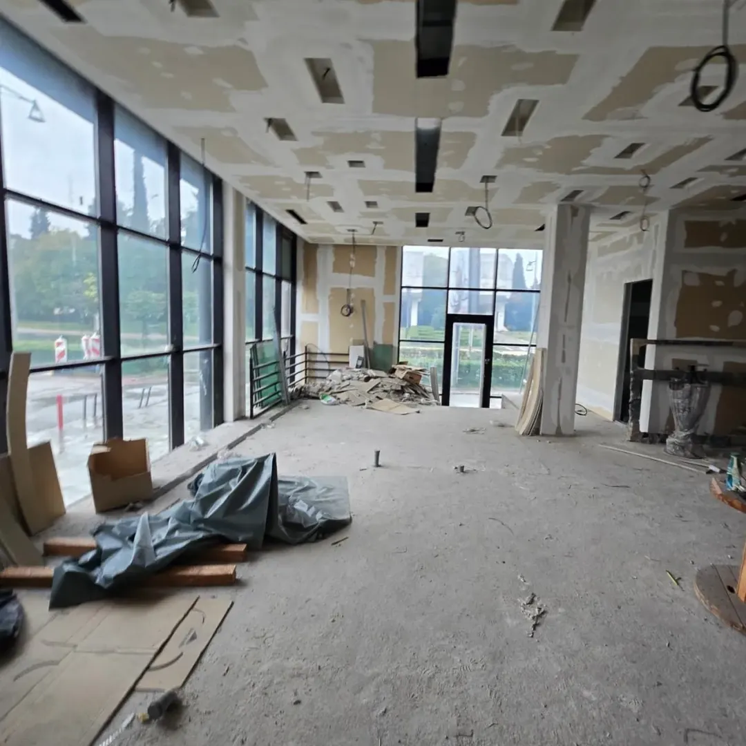 Large space under construction with large windows and an open view.