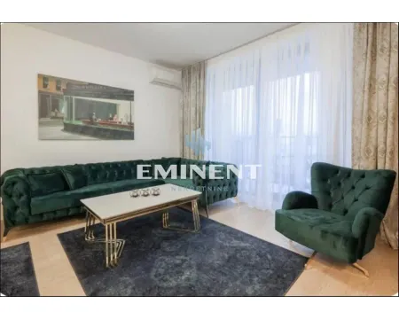 Living room with a green sectional sofa, armchair and coffee table. - image 3