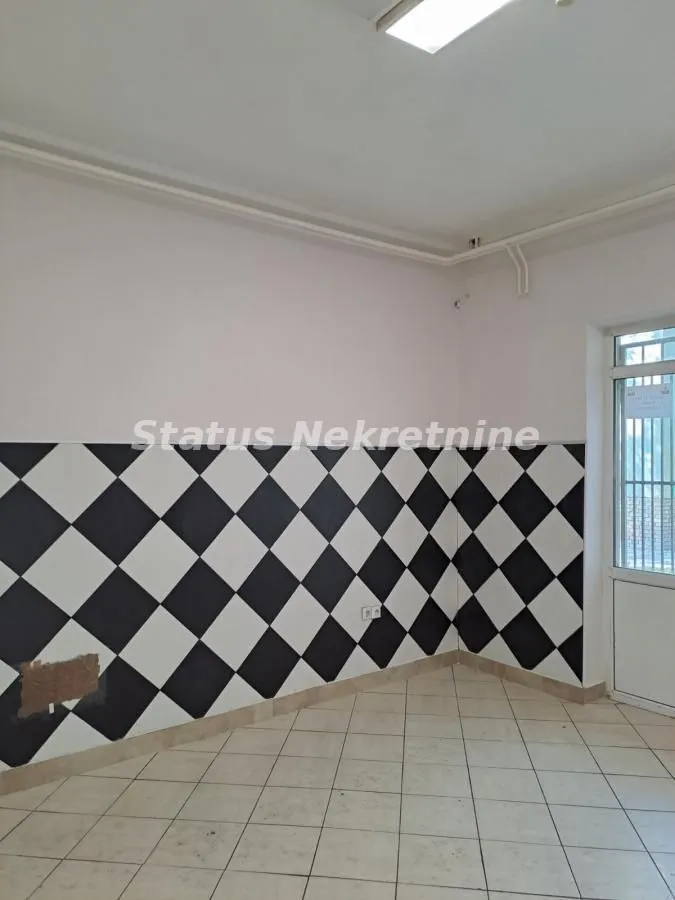 Empty room with black and white wall tiles and floor tiles.