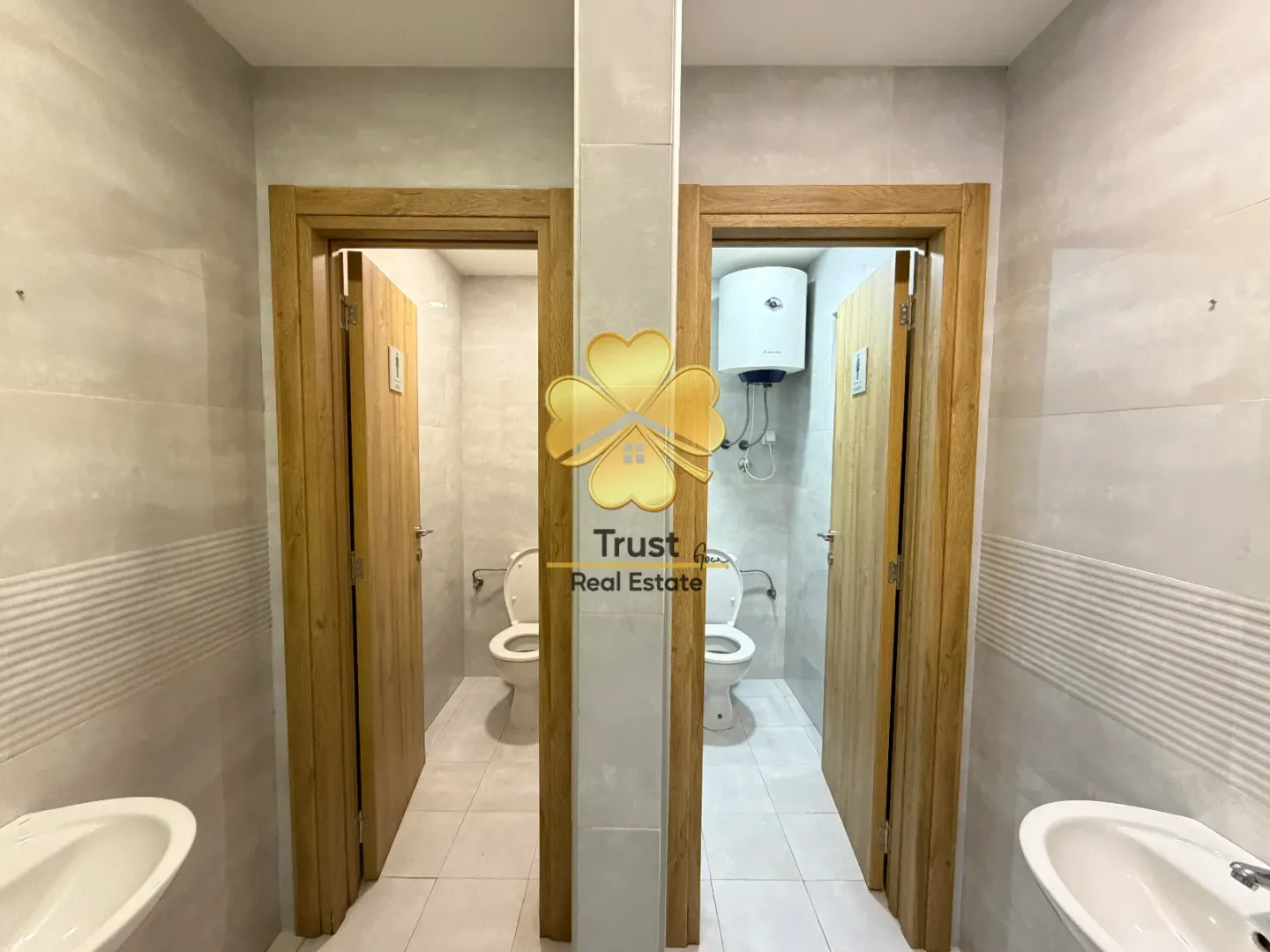 View of two bathrooms with sinks and toilets.