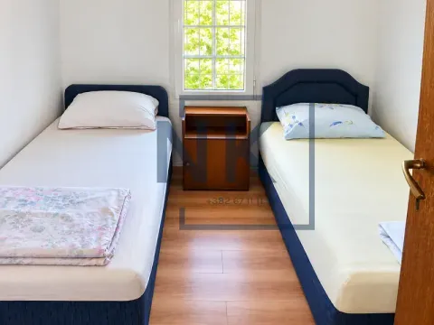 Spavaća soba sa dva odvojena kreveta i prozorom. - image 4