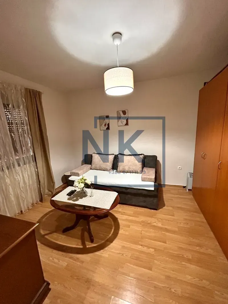 Living room with a sofa set, coffee table, and wooden wardrobe.
