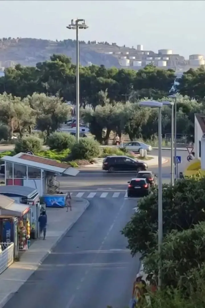 View from the terrace overlooking the street, roundabout, and surrounding greenery.