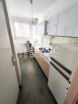 Small kitchen with white cabinets and a refrigerator. - image 7