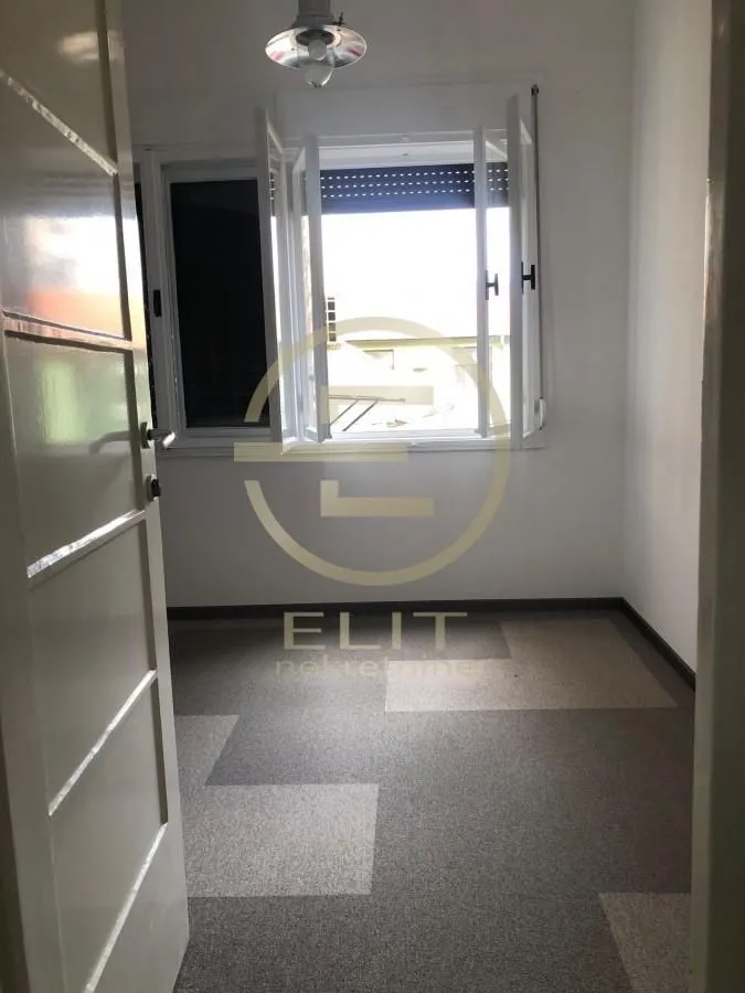 Empty room with a window and an open door.