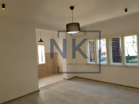 Empty living room with laminate flooring and windows. - image 8