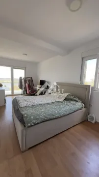 Spacious bedroom with a double bed, desk, and access to the terrace. - image 5