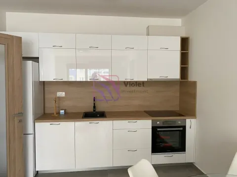Modern kitchen with white cabinets and a wooden worktop. - image 5