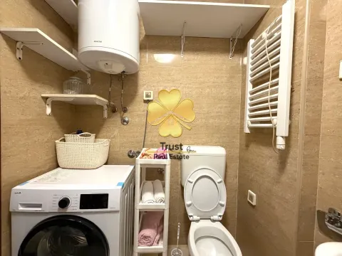 Small bathroom with washing machine, toilet, and water heater. - image 11