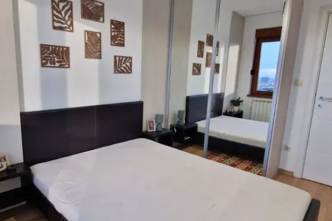 Bedroom with a double bed, bedside tables, and a large built-in wardrobe with a mirror. - image 6