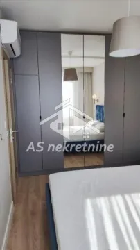 Bedroom with a large mirrored wardrobe and a double bed. - image 12