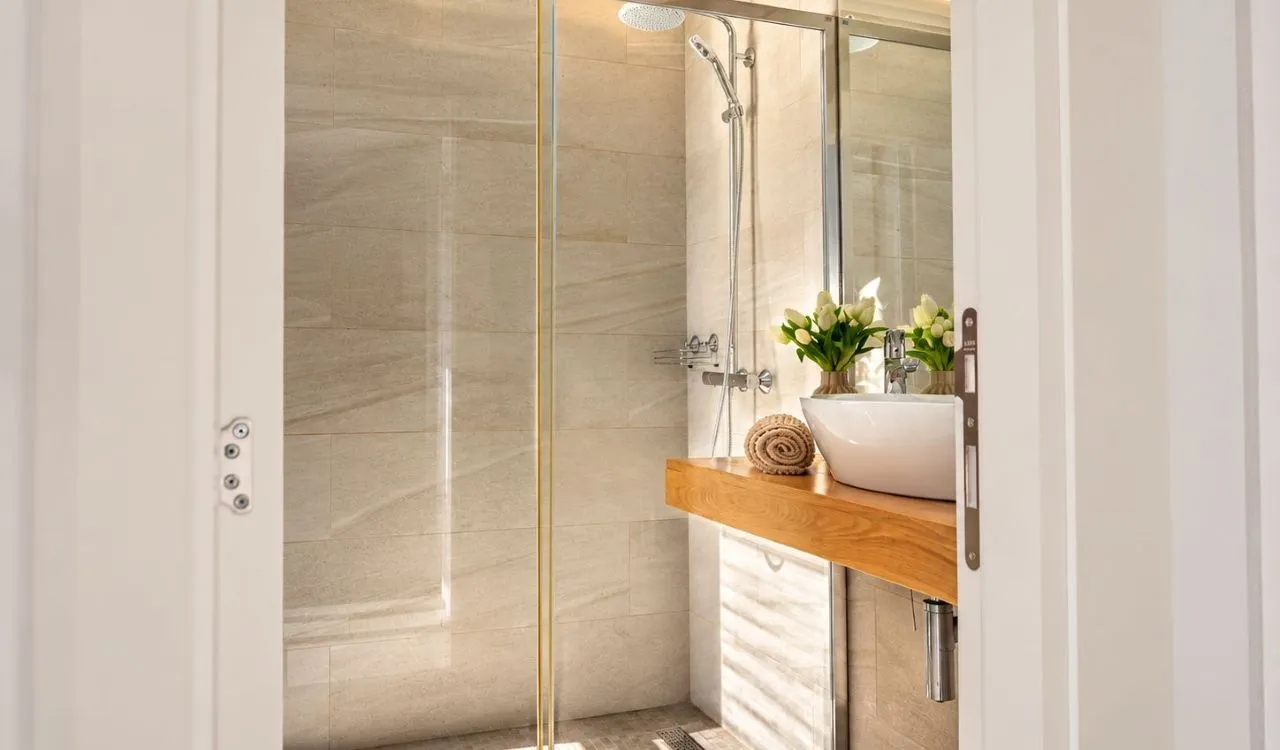 Modernly equipped bathroom with a shower cabin and a washbasin.