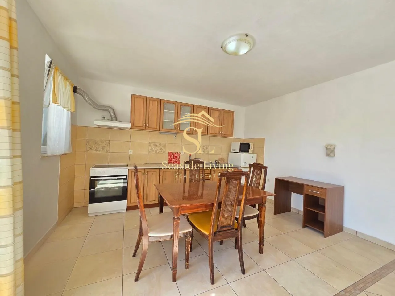Kitchen with wooden cabinets and a dining table.