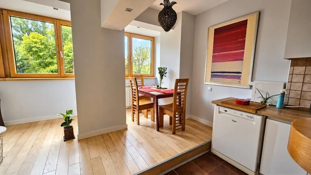 Small kitchen with a dining table and chairs near the window.