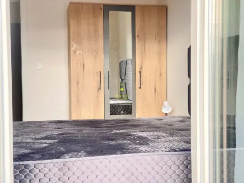 Furnished bedroom with a large wardrobe and bed. - image 6