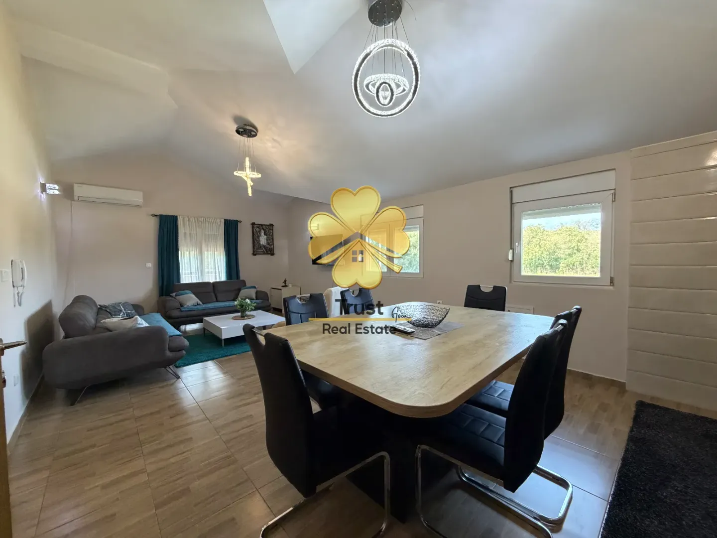 Spacious living room with a dining area and modern lighting.