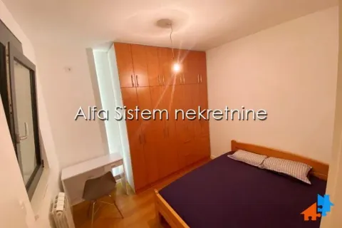 Furnished bedroom with a double bed, large wooden wardrobe, and a desk. - image 5