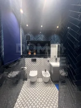 Modern bathroom with dark blue tiles and sanitaryware. - image 11