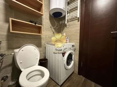 Smaller bathroom with toilet, washing machine, and water heater. - image 7