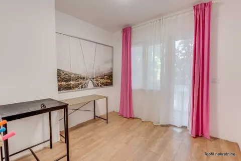 Room with a desk and a large picture on the wall. - image 6