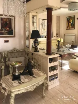 Living room with classic furniture, decorative details and a chandelier. - image 6