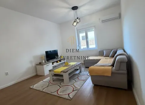 Living room with a corner sofa, TV, and coffee table. - image 7