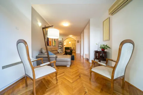 Spacious living room with seating set and hardwood flooring. - image 2