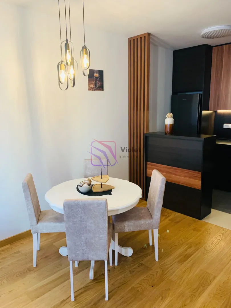 Dining area with a round table and chairs next to the kitchen.