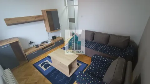 Living room with a sofa set, coffee table, and TV unit. - image 18