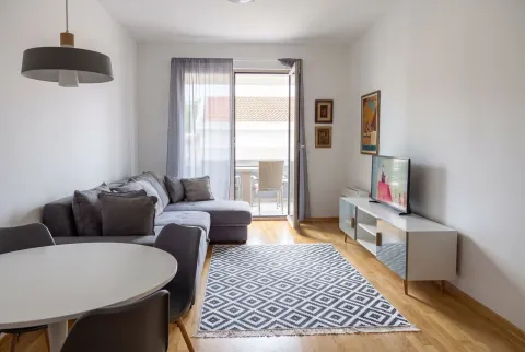 Living room with sofa, dining table, and access to the terrace. - image 2