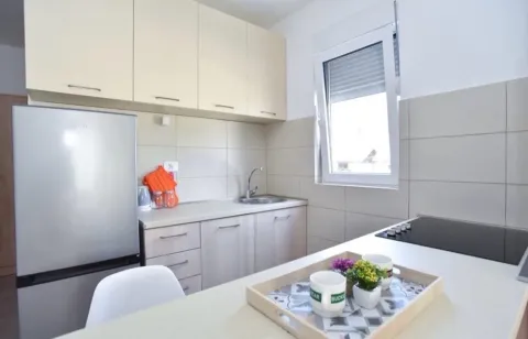 Small bright kitchen with basic units and a countertop. - image 5