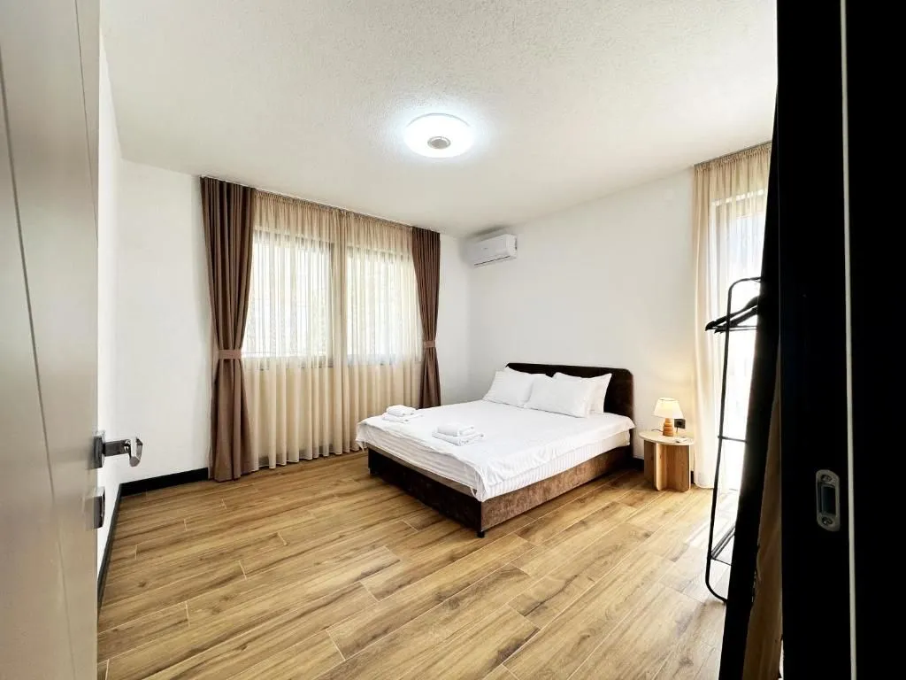 Bedroom with a double bed and wooden flooring.