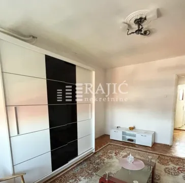 Furnished bedroom with a large wardrobe and a carpet on the floor. - image 2