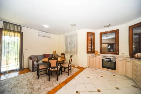 Living room with dining area and kitchen in an open plan space. - image 6