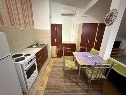 Small kitchen with a dining table and corner cabinets. - image 5