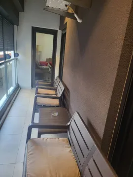 Narrow balcony with outdoor seating. - image 25
