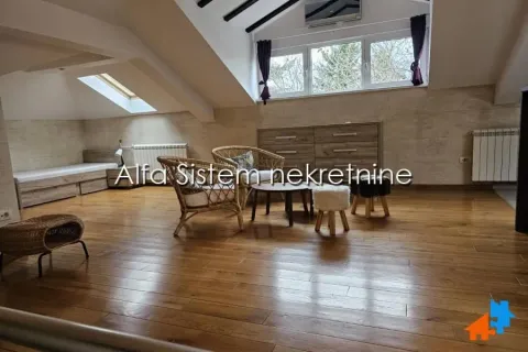 Attic space furnished as a living room with seating area and wooden flooring. - image 8